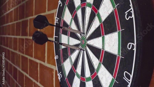 Throw 3 darts at the darts board. slow motion