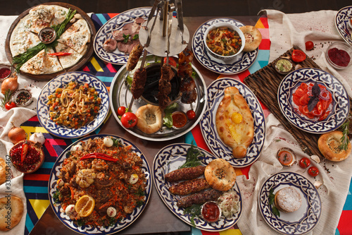 Dishes of Uzbek cuisine on a red background and beautiful decoration.