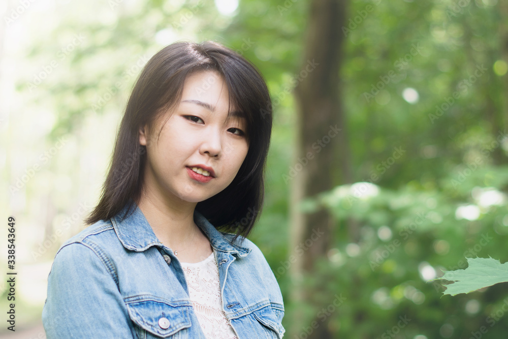 Portrait of a beautiful Asian young girl in nature. Copy space. Portrait of a beautiful Asian young girl in nature. Copy space.