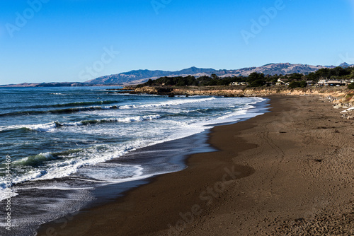 Rock And Sand Beach With Breaking Waves