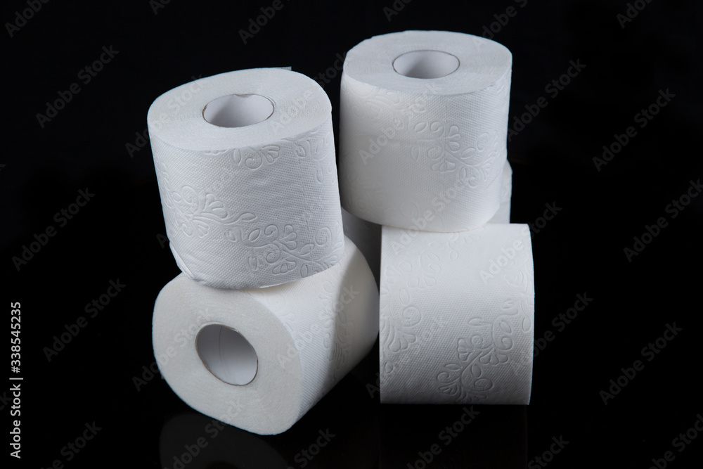 Toilet paper is white on a black background. Hygiene products. Toilet paper is white on a black background. Hygiene products.