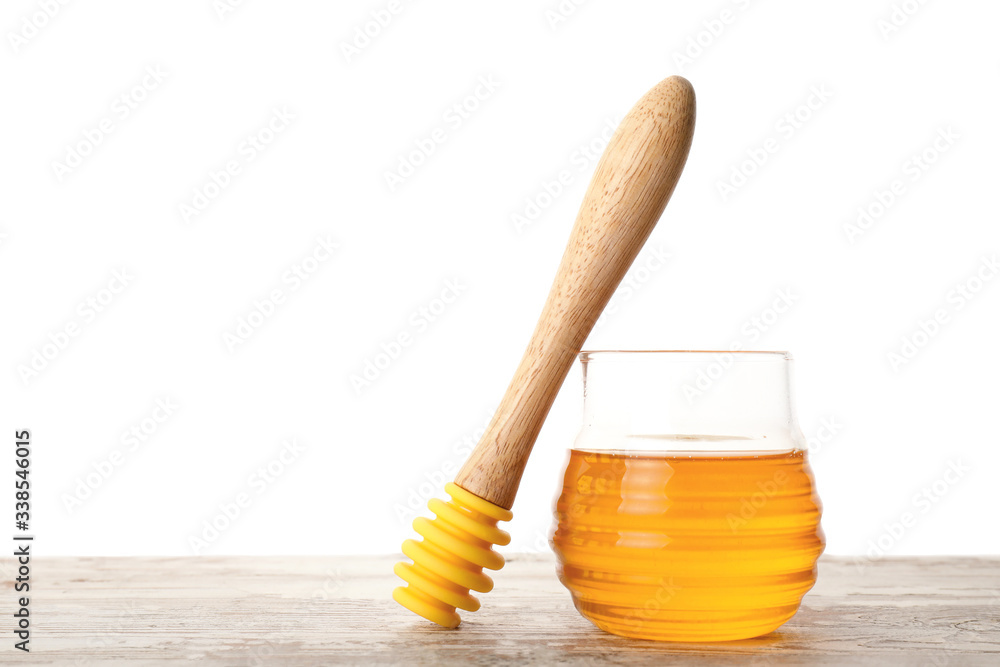 Jar of sweet honey on table against white background Jar of sweet honey on table against white background