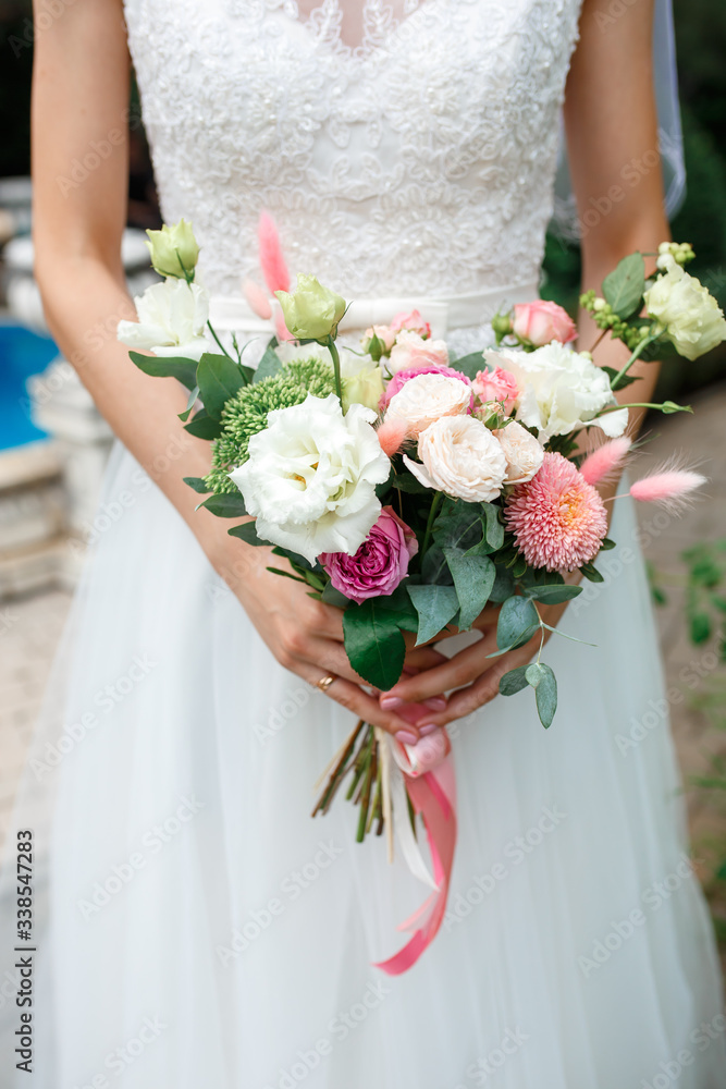 Beautiful wedding flowers in hands of the bride. Beautiful wedding flowers in hands of the bride.