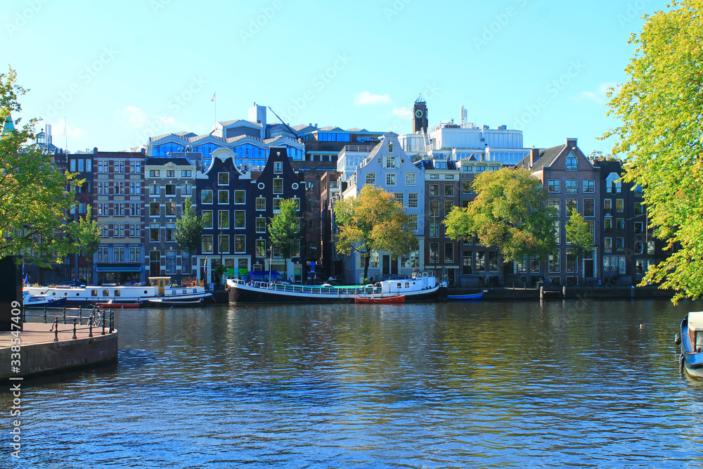 Naklejka premium View of the canal and the streets of Amsterdam in summer