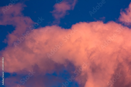 pink clouds on a background of blue sky at sunset © юлия саплина