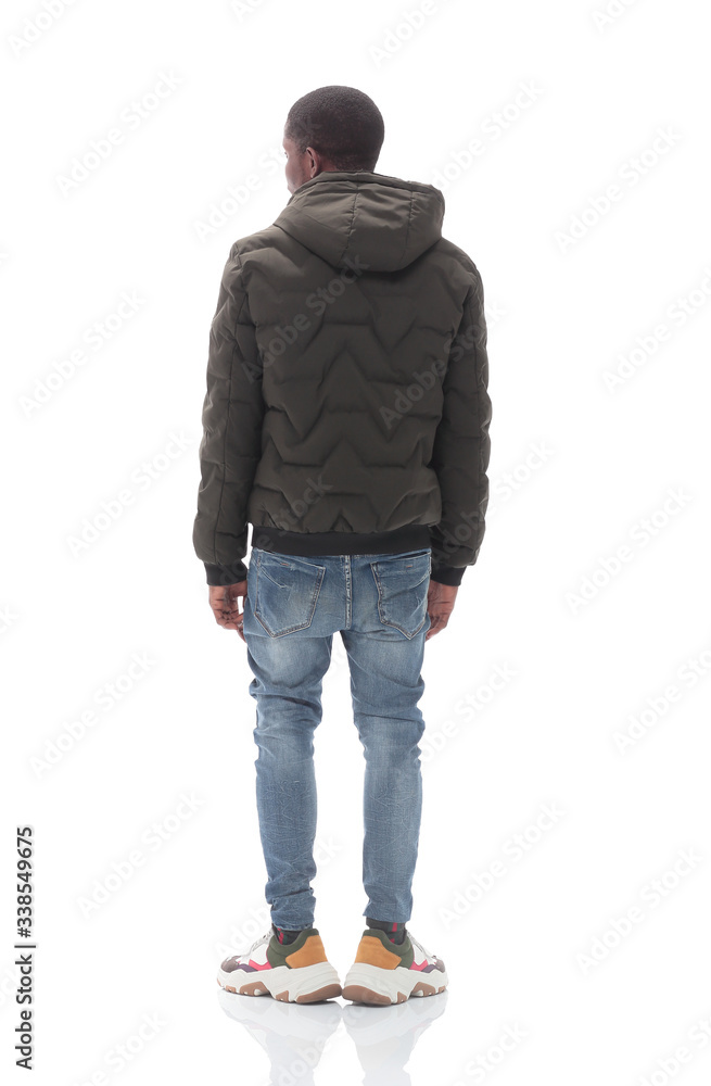 Naklejka premium casual guy in black jacket looking at white wall