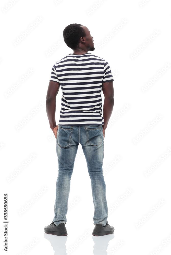 rear view. a young man reading something on a white wall rear view. a young man reading something on a white wall