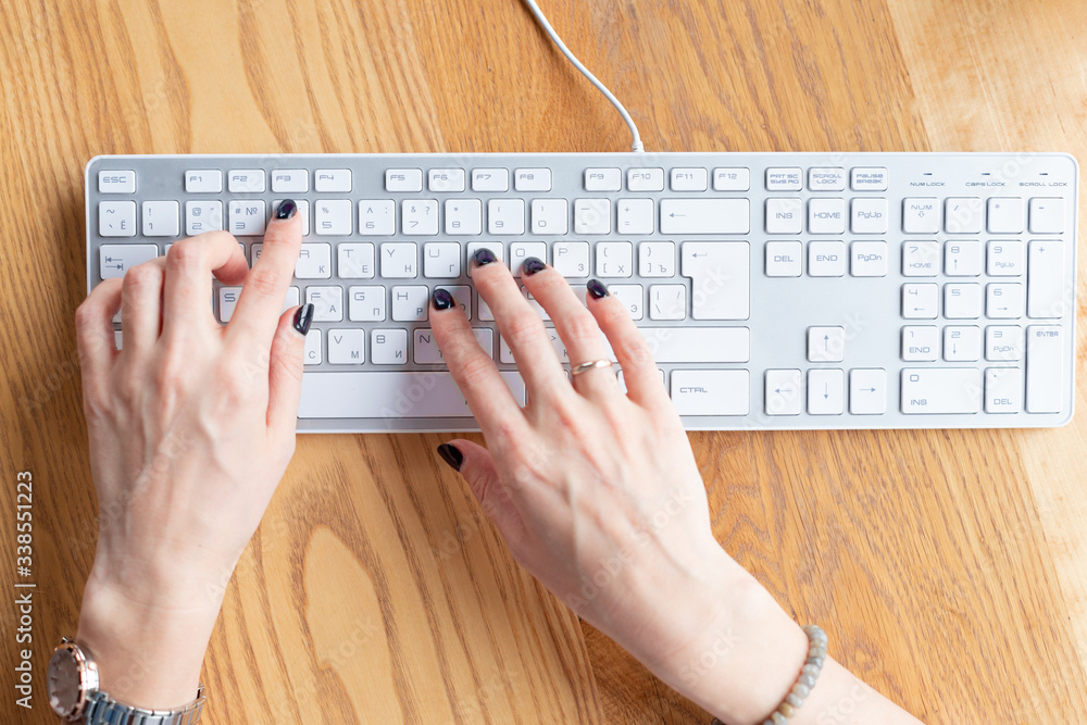 Hands of business woman with black manicure typing on keyboard at home office. Distance learning.Hands,manicure. Wooden table,organizer.Remote work place.Quarantine of coronovirus pandemic covid-19 Hands of business woman with black manicure typing on keyboard at home office. Distance learning.Hands,manicure. Wooden table,organizer.Remote work place.Quarantine of coronovirus pandemic covid-19
