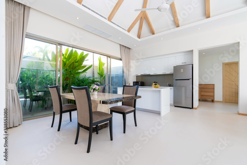 Interior design of open space dining room and kitchen in pool villa, house, home, condo and apartment feature kitchenette © korakoch