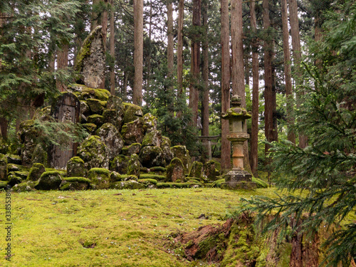 A quiet and peaceful garden with stones and trees on an overcast day in Japan