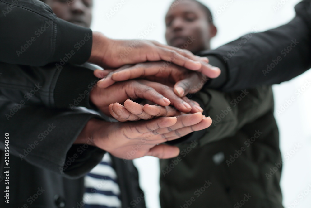 © ASDF - close up. a group of friends putting their hands togethe © ASDF - close up. a group of friends putting their hands togethe