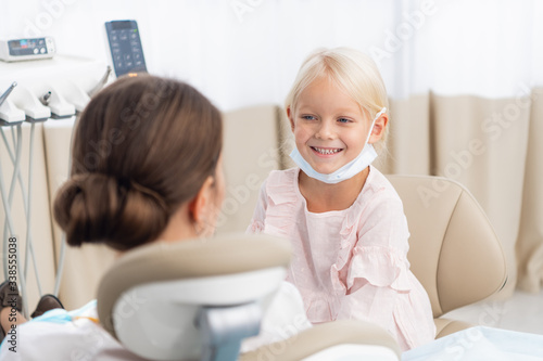 Young patient undergoing a usual check-up procedure at the dentist s