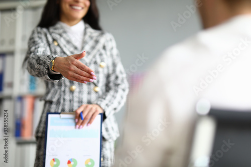 Photography Close-up of cheerful employee extend hand for handshaking
