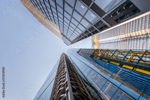 Looking up a reflections on glass covered corporate building