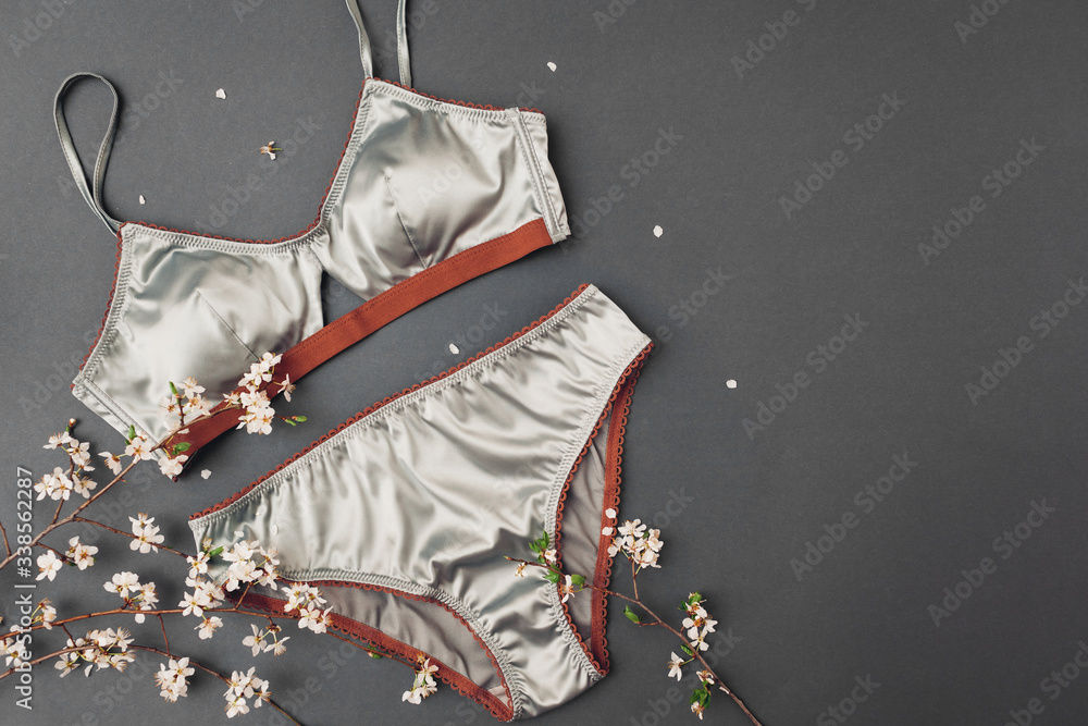 Set of female silk underwear with spring blossom. Satin bra with lace and  panties. Sexy clothing for women with flowers Stock Photo