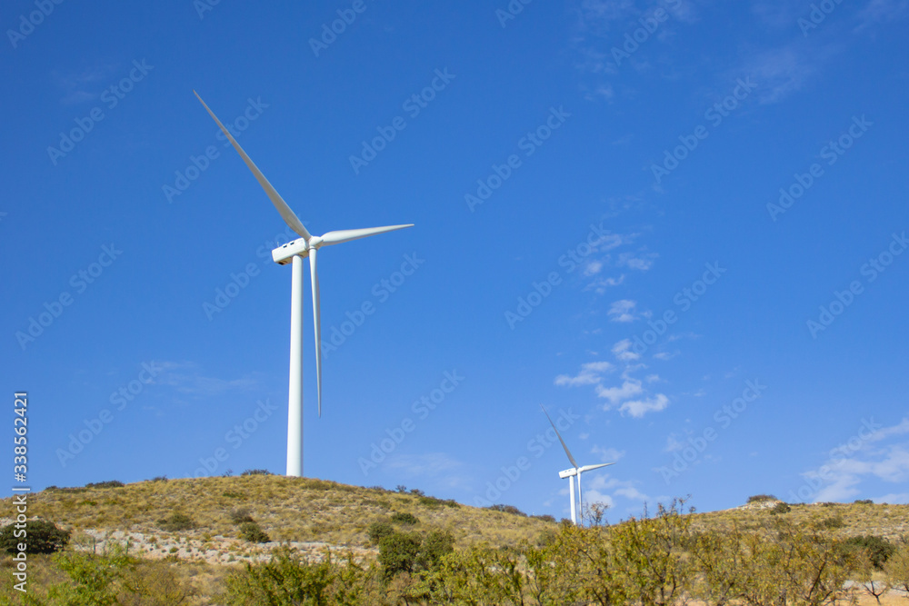 Landscape with wind turbine moving its blades generating alternative renewable energy for the environment Landscape with wind turbine moving its blades generating alternative renewable energy for the environment