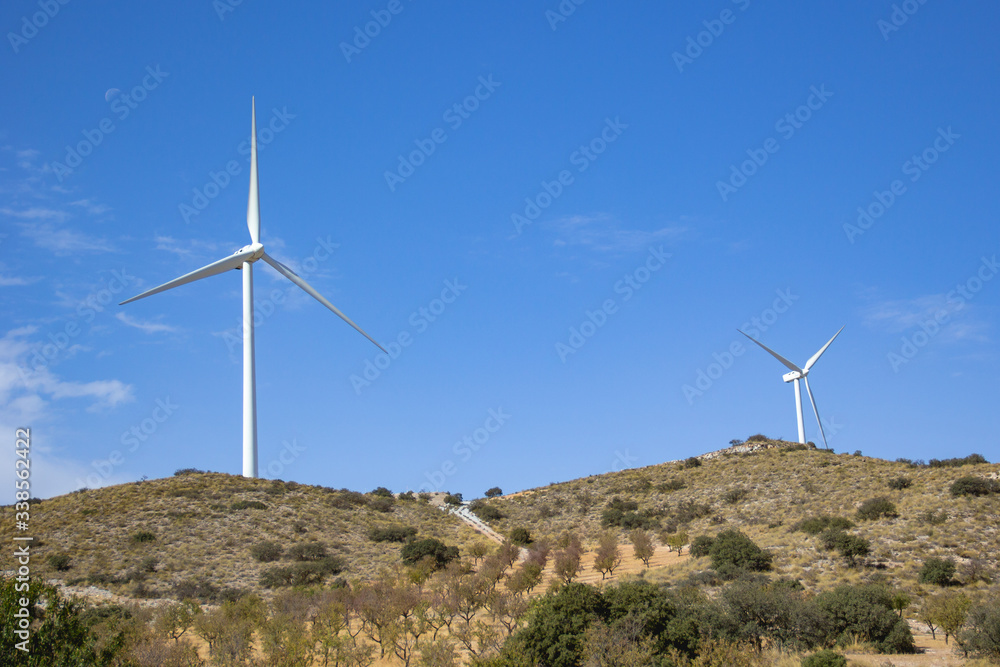 Landscape with wind turbine moving its blades generating alternative renewable energy for the environment Landscape with wind turbine moving its blades generating alternative renewable energy for the environment
