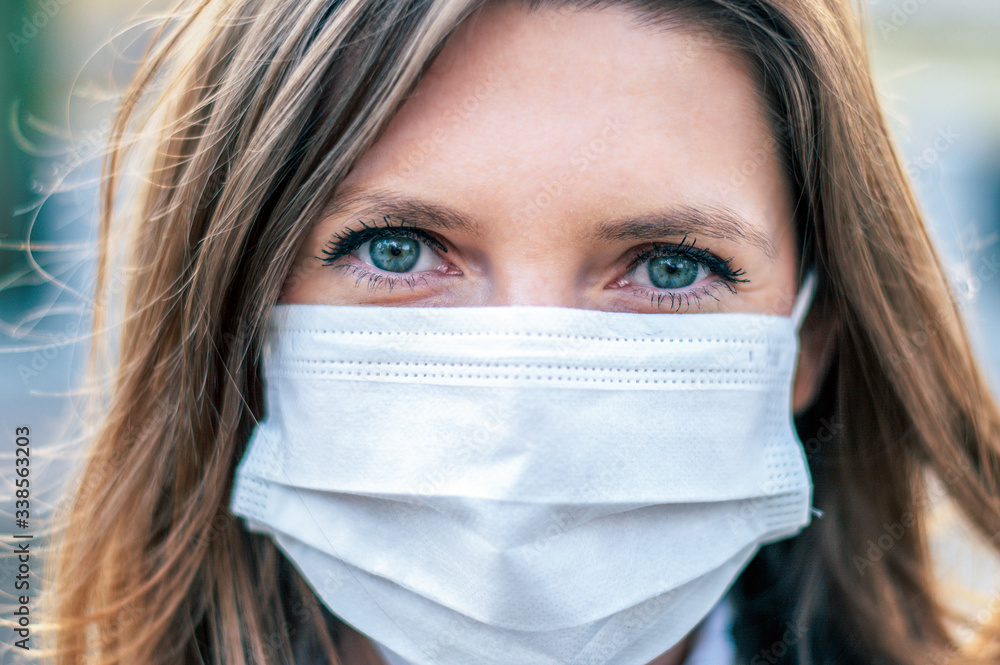 Virus mask. COVID-19. Woman walking in public space wearing face protection in prevention for coronavirus.