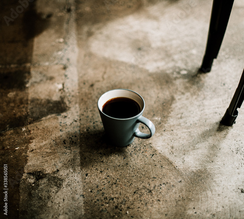 cup of coffee on a rough concrete ground