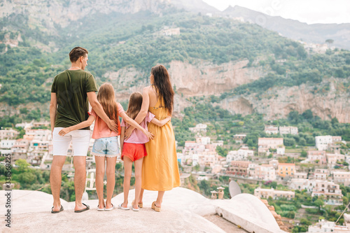 Parents and kids taking selfie photo background Positano town in Itali on Amalfi coast