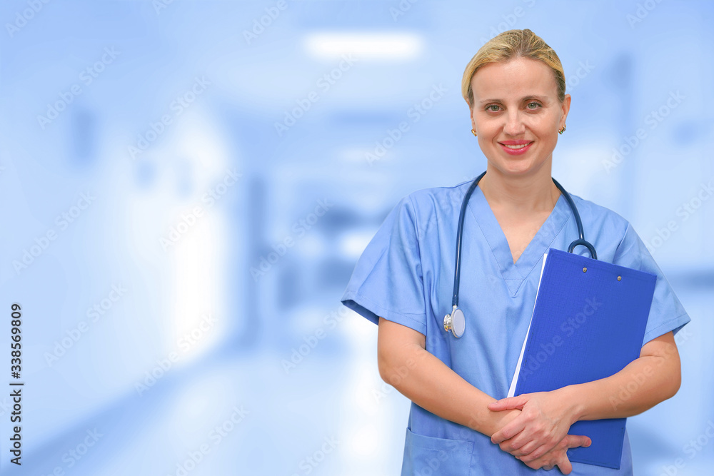 Doctor or surgeon with a folder on the background of a blurred corridor of the clinic. Medical web sites with copy space. Health care banner. Doctor or surgeon with a folder on the background of a blurred corridor of the clinic. Medical web sites with copy space. Health care banner.