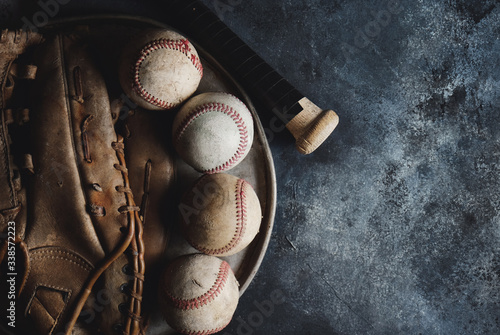Photography Old vintage baseball glove and balls on dark texture background.