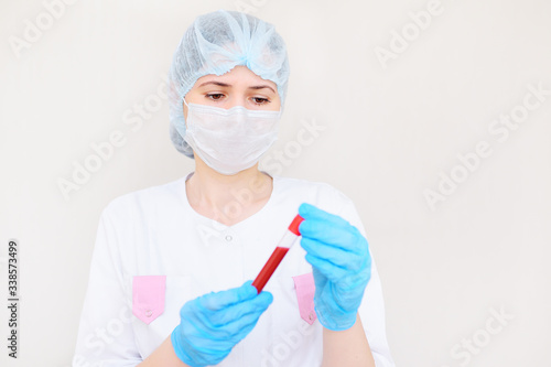 a female doctor or nurse holds a test tube with a blood sample. Copy space  space for text