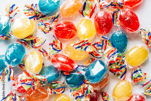 Mix of hard wrapped candies isolated on white background.