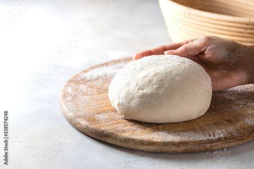 Homemade bread. Woman hands kneading fresh dough for making bread.