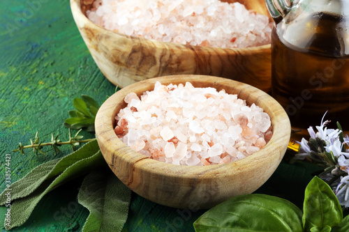 Crystals of salt on table. himalayan salt in powl photo