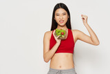 young woman holding a red apple