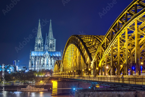 Panorama of the Hohenzollern Bridge over the Rhine River and Cologne Cathedral by night  Cologne city skyline Germany Skyline von K  ln mit K  lner Dom und Hohenzollernbr  cke bei Nacht.