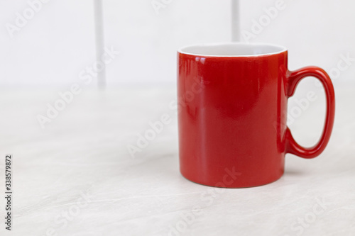 Red cup above white background with copy space