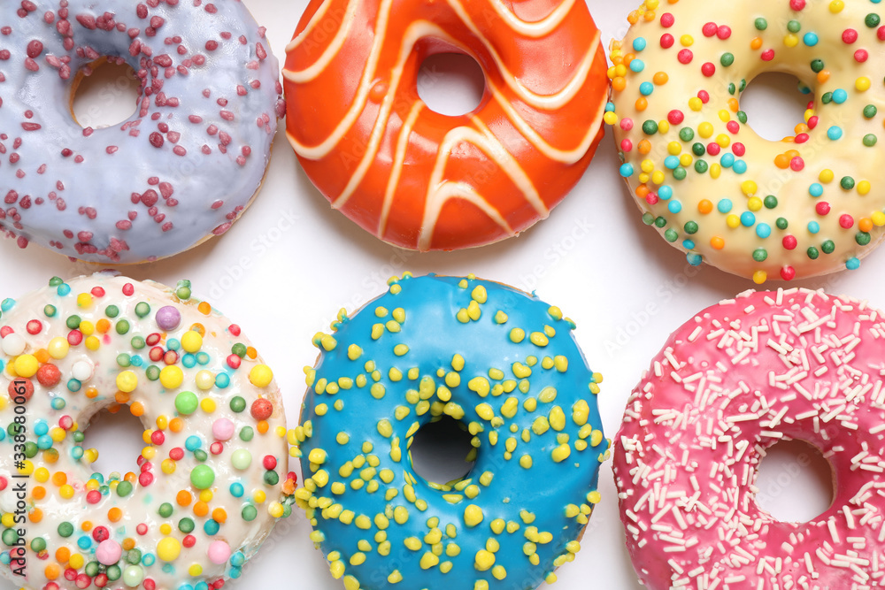 Delicious glazed donuts on white background, flat lay Delicious glazed donuts on white background, flat lay