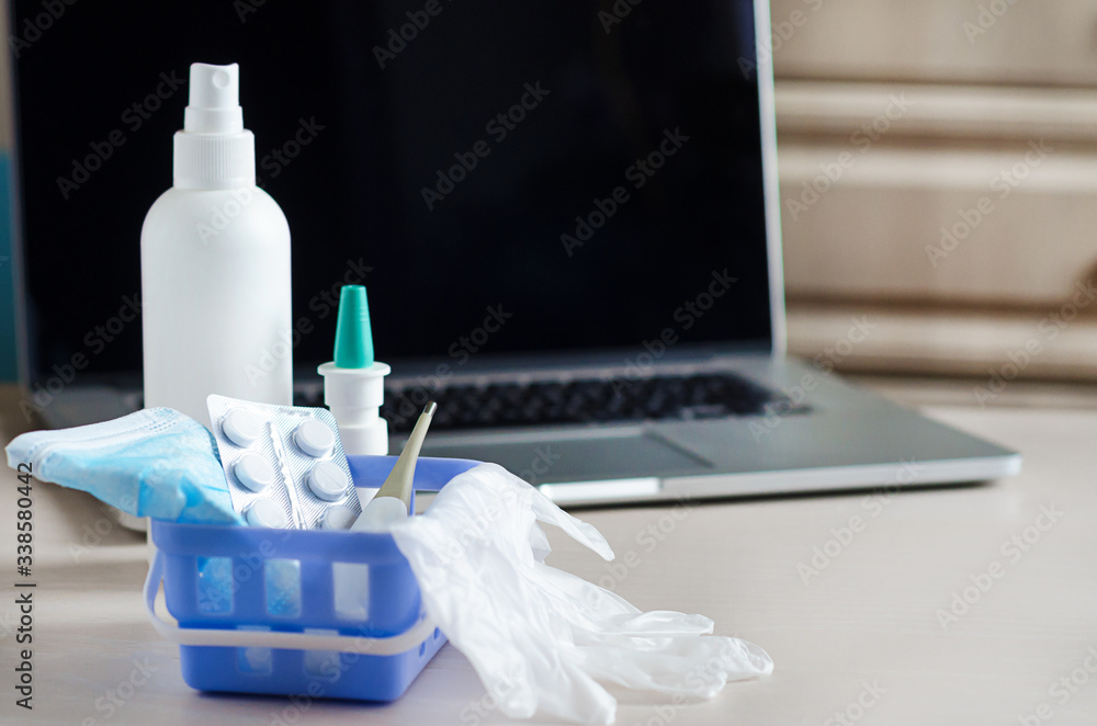 delivery of medicines to your home. home first aid kit for colds, illnesses, viruses, epidemics. online purchase of medicines. drugs in basket in front of laptop, copy space delivery of medicines to your home. home first aid kit for colds, illnesses, viruses, epidemics. online purchase of medicines. drugs in basket in front of laptop, copy space