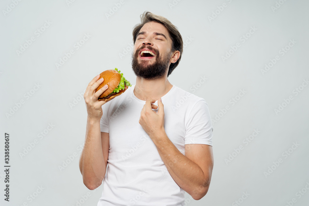 young man holding an apple and smiling young man holding an apple and smiling