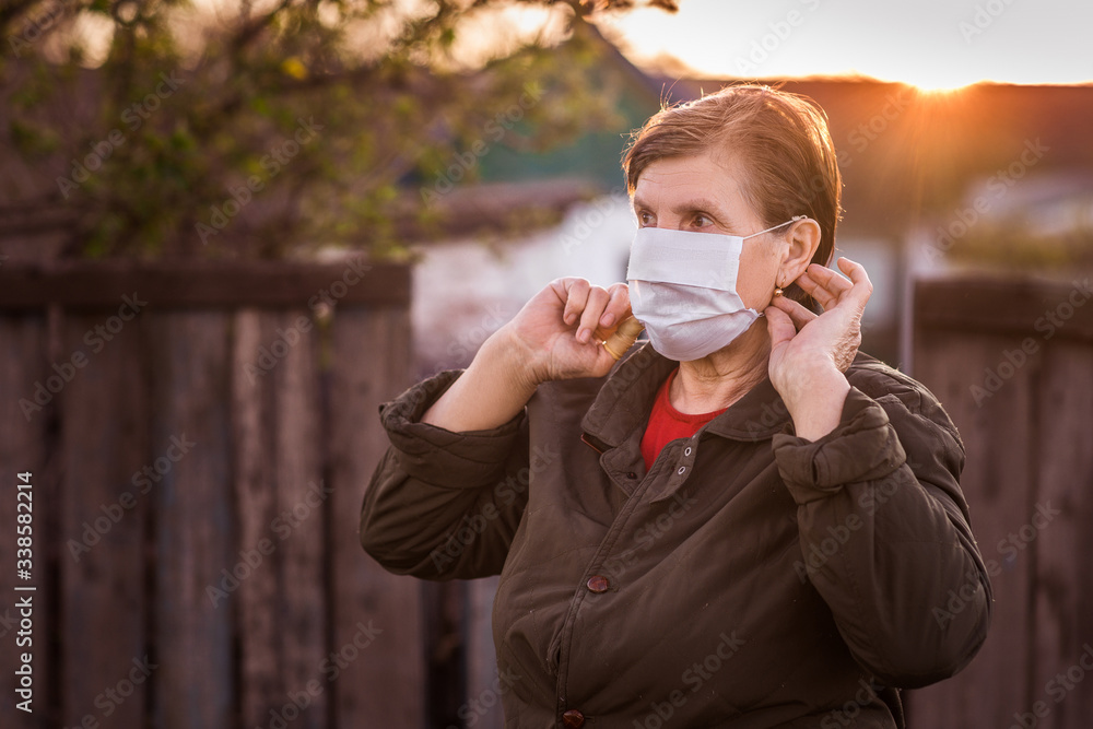 Senior woman wearing facial mask during outbreak of corona virus and flu. Protection against diseases and illnesses. Surgical masks for the prevention of coronavirus. Senior woman wearing facial mask during outbreak of corona virus and flu. Protection against diseases and illnesses. Surgical masks for the prevention of coronavirus.