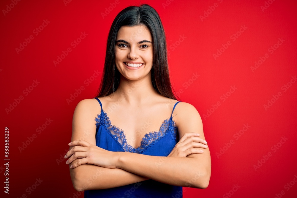 Naklejka premium Young beautiful brunette woman wearing elegant and comfortable lingerie underwear happy face smiling with crossed arms looking at the camera. Positive person.