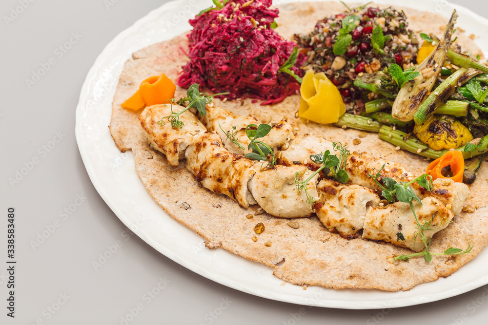 Grilled chicken tikka yoghurt with salad side dish. beetroot, asparagus, and quinoa. Perfect for healthy living vegetarian. Organic food photography concept.