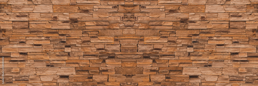 Background Modern building facade made of decorative stone, panorama. Brick or stone wall texture, banner. Texture of the stone surface. Background Modern building facade made of decorative stone, panorama. Brick or stone wall texture, banner. Texture of the stone surface.