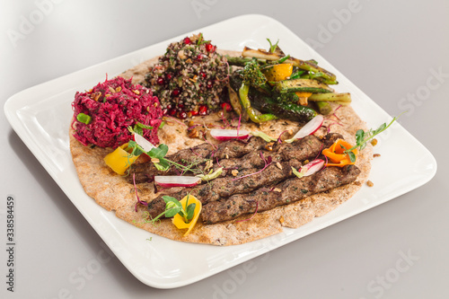 Delicious homemade kebab with salad side dish. beetroot, asparagus, and quinoa. Organic food photography takeaway and delivery concept.