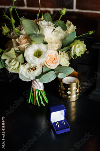 Wedding bridal bouquet of flowers and greenery is on a black table