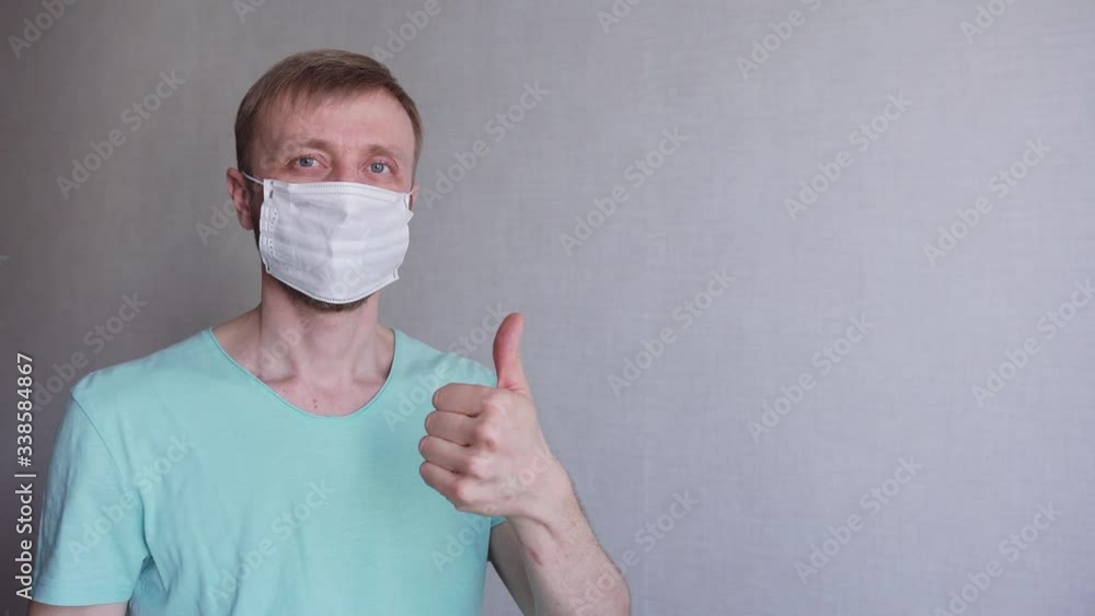 young man with a beard wears a medical mask young man with a beard wears a medical mask