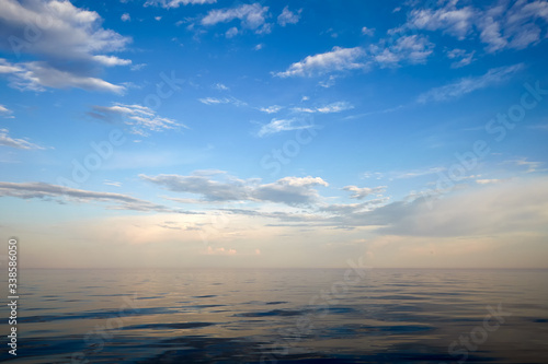 Serene, calm lake. Gentle blue sky with white clouds. © Yuriy Kozak