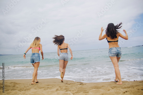 happy girlfriends on the sea sand
