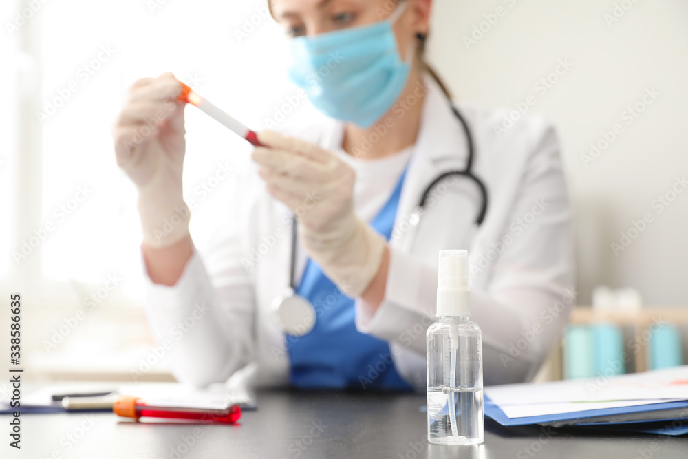 Bottle of disinfectant on workplace of doctor in clinic. Concept of epidemic Bottle of disinfectant on workplace of doctor in clinic. Concept of epidemic