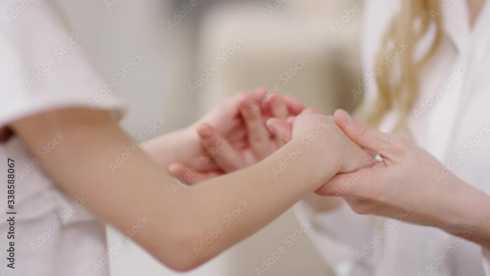 Close up of unrecognizable mother holding hands of her little daughter Close up of unrecognizable mother holding hands of her little daughter