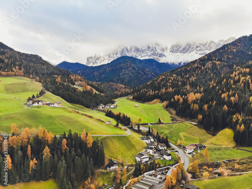 Sunset over the peaks of Puez Odle Nature Park in South Tyrol, Italy. the village of San Pietro. photo