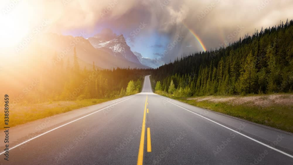 Cinemagraph Continuous Loop Animation. Scenic road in the Canadian Rockies during a vibrant sunny summer sunrise. Sky with Sunrays. Taken in Icefields Parkway, Banff National Park, Alberta, Canada. Cinemagraph Continuous Loop Animation. Scenic road in the Canadian Rockies during a vibrant sunny summer sunrise. Sky with Sunrays. Taken in Icefields Parkway, Banff National Park, Alberta, Canada.