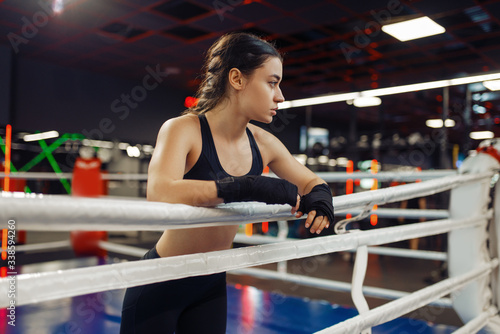 Woman in boxing bandages at the ropes on ring © Nomad_Soul